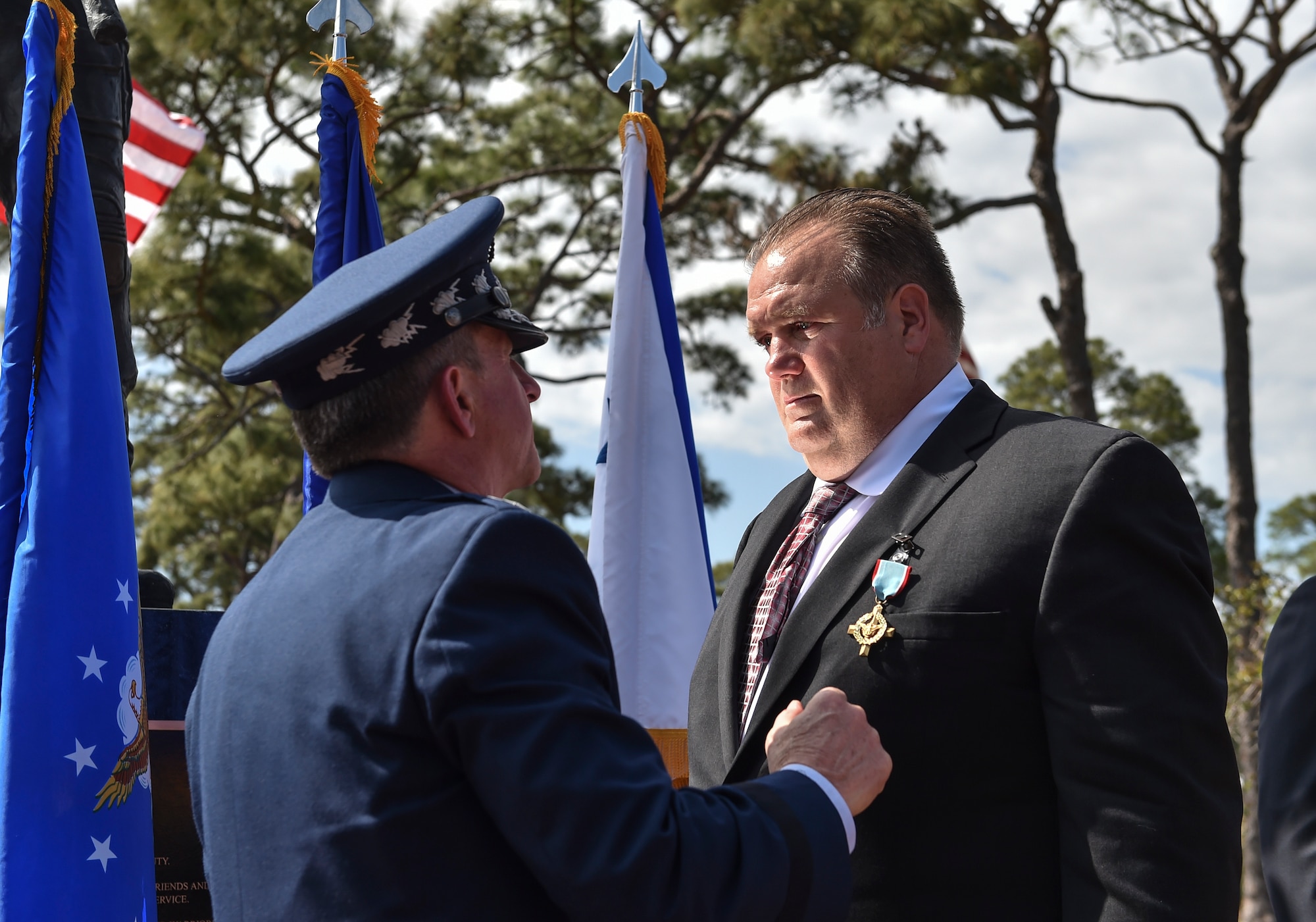 Chief of Staff of the Air Force, Gen. David L. Goldfein, presents Master Sgt. (Ret.) Keary Miller, a retired Special Tactics pararescueman, the Air Force Cross at Hurlburt Field, April 20, 2017. For the first time in Air Force history, two Airmen were simultaneously awarded the service’s highest medal for valorous action in combat. Miller, from the Air National Guard’s 123rd Special Tactics Squadron, and Chris Baradat, a staff sergeant combat controller at the time, both received Silver Star medals for their actions in combat, which were upgraded after a service-wide review. (U.S. Air Force photo by Senior Airman Ryan Conroy) 