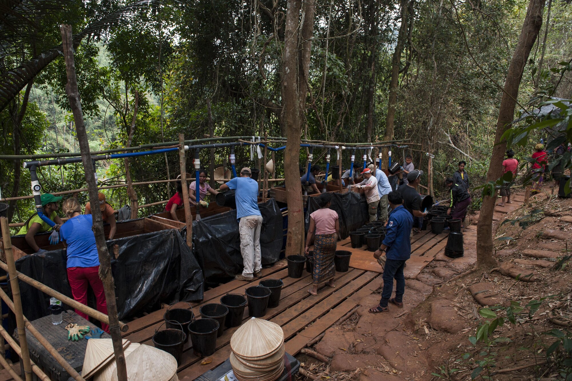 U.S. service members work with citizens of the Lao People’s Democratic Republic at a wet screen station March 16, 2017, in the Khommouon province in the country of Laos. The Defense Prisoner of War/Missing in Action Agency works with other countries to recover America’s missing heroes.  The mission of DPAA is to provide the fullest possible accounting for our missing personnel to their families and the nation. (U.S. Air Force photo by Senior Airman Lynette M. Rolen/Released)