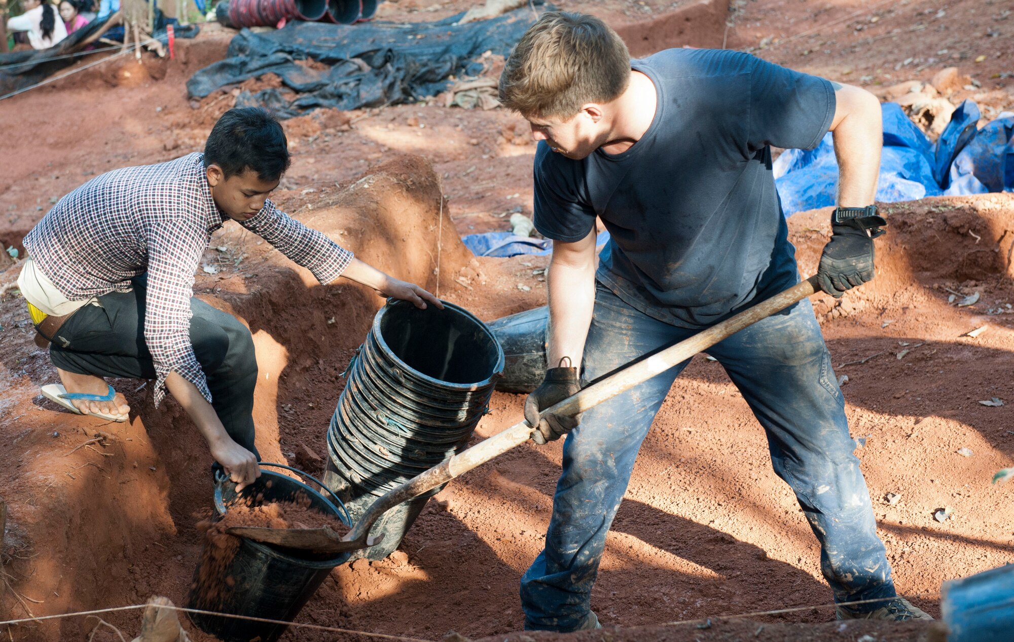 U.S. Navy Petty Officer Second Class Matthew Chamberlain, Naval Information Operations Command Hawaii yeoman, excavates with a citizen of the Lao People’s Democratic Republic March 24, 2017, in the Khommouon province in the country of Laos. Partnerships with different countries guarantee mission continuity with the Defense Prisoner of War/Missing in Action Agency of returning America’s missing heroes home. The mission of DPAA is to provide the fullest possible accounting for our missing personnel to their families and the nation. (U.S. Air Force photo by Senior Airman Lynette M. Rolen/Released)