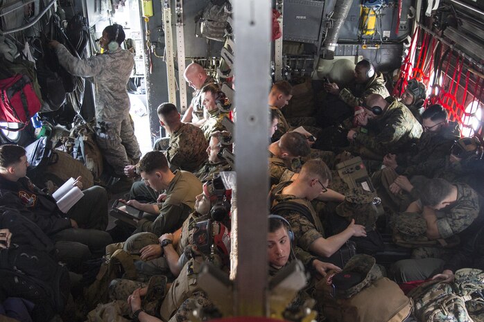 U.S. Marines with Marine Attack Squadron (VMA) 311 travel aboard a C-130 Hercules during an exercise to Kunsan Air Base, Republic of Korea, from Marine Corps Air Station Iwakuni, Japan, April 12, 2017. VMA 311 is participating in Exercise MAX THUNDER 17, an operational readiness exercise built to promote interoperability between U.S. and ROK forces. This annual exercise helps to promote stability in the Asia-Pacific region. (U.S. Marine Corps photo by Lance Cpl. Carlos Jimenez)