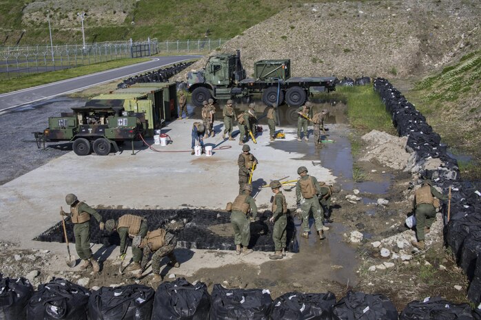 U.S. Marines with Marine Wing Support Squadron (MWSS) 171, execute airfield damage and repair training at Marine Corps Air Station Iwakuni, Japan, April 19, 2017. The ADR training required Marines to utilize their skill set to tactically and proficiently fix any anomalies to a simulated damaged airfield. The training focused on becoming more efficient in situations that may require Marines to act in real-world scenarios to maintain the tempo of aircraft operations. (U.S. Marine Corps photo by Lance Cpl. Joseph Abrego)
