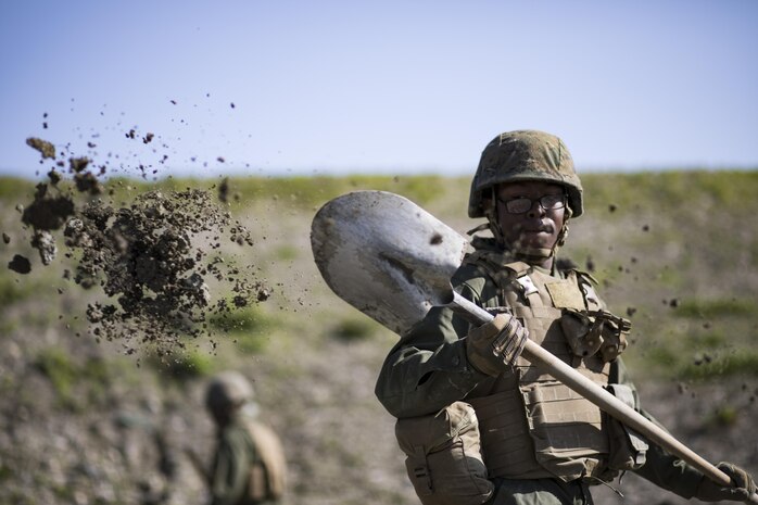U.S. Marine Corps Pfc. Jason Taylor, a combat engineer with Marine Wing Support Squadron (MWSS) 171, shovels dirt and mud during airfield damage and repair training at Marine Corps Air Station Iwakuni, Japan, April 19, 2017. The ADR training required Marines to utilize their skill set to tactically and proficiently fix any anomalies to a simulated damaged airfield. The training focused on becoming more efficient in situations that may require Marines to act in real-world scenarios to maintain the tempo of aircraft operations. (U.S. Marine Corps photo by Lance Cpl. Joseph Abrego)