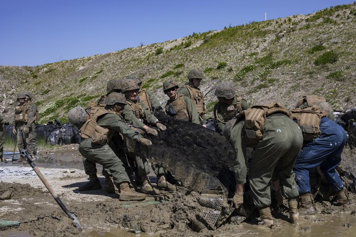 U.S. Marines with Marine Wing Support Squadron (MWSS) 171, prepare a simulated crater in the runway for repair during airfield damage and repair training at Marine Corps Air Station Iwakuni, Japan, April 19, 2017. The ADR training required Marines to utilize their skill set to tactically and proficiently fix any anomalies to a simulated damaged airfield. The training focused on becoming more efficient in situations that may require Marines to act in real-world scenarios to maintain the tempo of aircraft operations. (U.S. Marine Corps photo by Lance Cpl. Joseph Abrego)