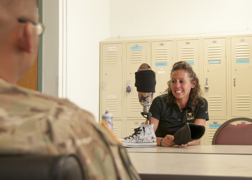 Army Capt. Kelly Elmlinger, a military nurse and cancer survivor, displays her prosthetic leg to nurses of William Beaumont Army Medical Center’s surgical ward at Fort Bliss, Texas, where she shared her experiences during her fight with synovial sarcoma, a rare soft-tissue cancer, April 6, 2017. Elmlinger, who is coaching and mentoring wounded warriors during this year’s Department of Defense Warrior Games, visited with staff members to help them understand the impact medical staff can have on patients. Army photo by Marcy Sanchez