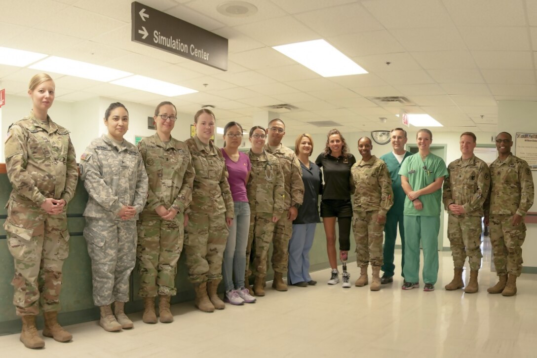 Army Capt. Kelly Elmlinger, a military nurse and cancer survivor, center, visits with staff members at William Beaumont Army Medical Center’s surgical ward at Fort Bliss, Texas, where she shared her experiences during her fight with synovial sarcoma, a rare soft-tissue cancer, April 6, 2017. Elmlinger, who is coaching and mentoring wounded warriors during this year’s Department of Defense Warrior Games, visited with staff members to help them understand the impact medical staff can have on patients. Army photo by Marcy Sanchez