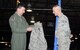 Staff Sgt. Caley Cramer, center, a vehicle maintenance technician with the 55th Logistics Readiness Squadron at Offutt Air Force Base, Nebraska, looks on as Col. Marty Reynolds, left, 55th Wing commander, presents Cramer with an ABU top detailing his new rank April 3, 2017. Cramer had been step promoted with only two weeks left before he was to take terminal leave after reaching higher tenure last year.