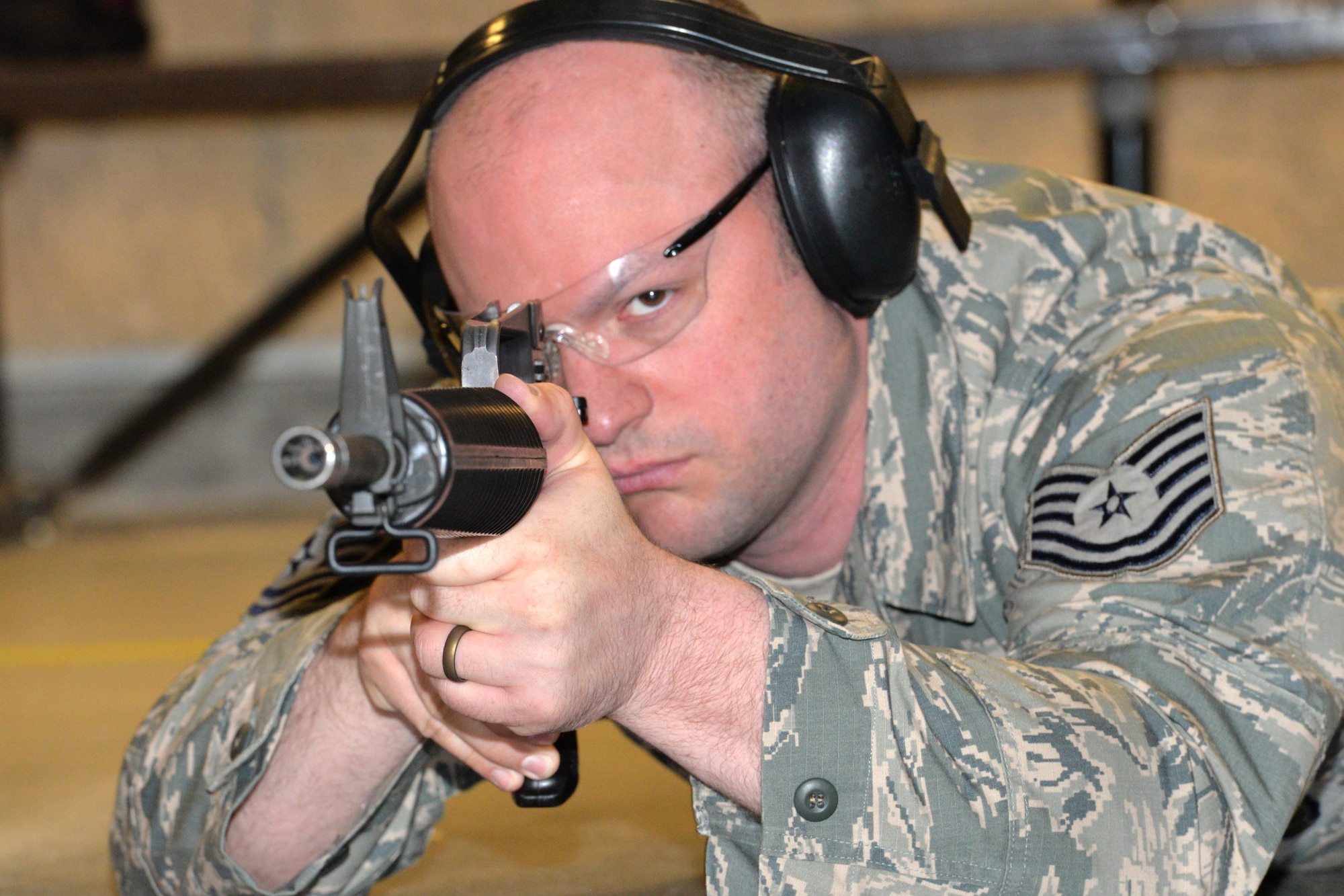 Staff Sgt. Burt Perry, 88th Security Forces Squadron operations staff non-commissioned officer, carefully aims his M-16 rifle at his target during the pistol and rifle Excellence in Competition contest at the 88th Security Forces Squadron gun range, Apr. 12, at Wright-Patterson Air Force Base, Ohio. The EIC contest, conducted Air Force-wide, was open to all  open to  active duty, Guard, Reserve, retiree and civil service employees, April 3-13, 2017. (U.S. Air Force photo/Al Bright)