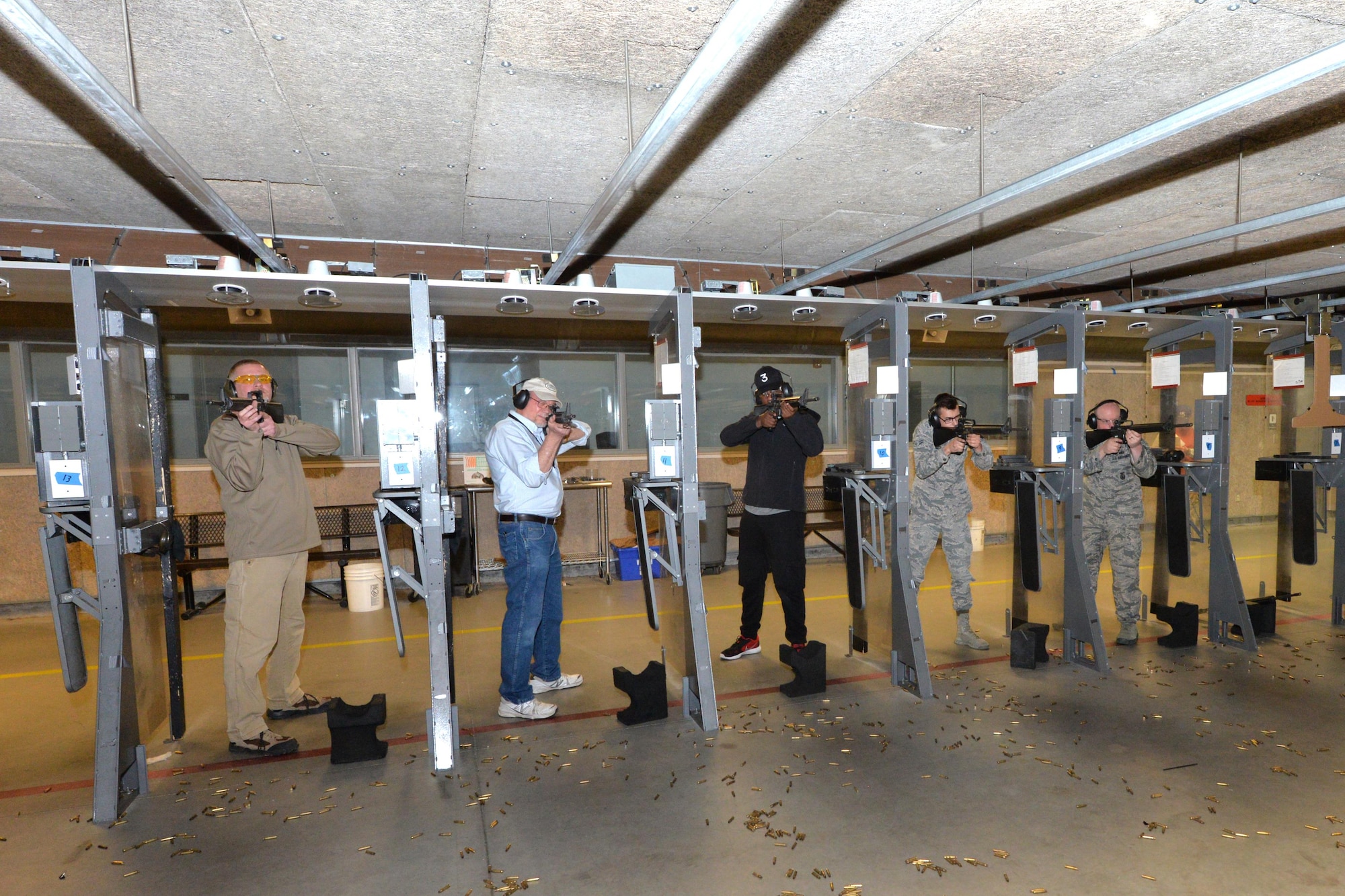 Participants fire at their respective targets during the pistol and rifle Excellence in Competition contest at the 88th Security Forces Squadron gun range, Apr. 12, at Wright-Patterson Air Force Base, Ohio. The Apr. 3-13 EIC event conducted Air Force-wide was open to all active duty, Guard, Reserve, retiree and civil service employees. (U.S. Air Force photo/Al Bright)