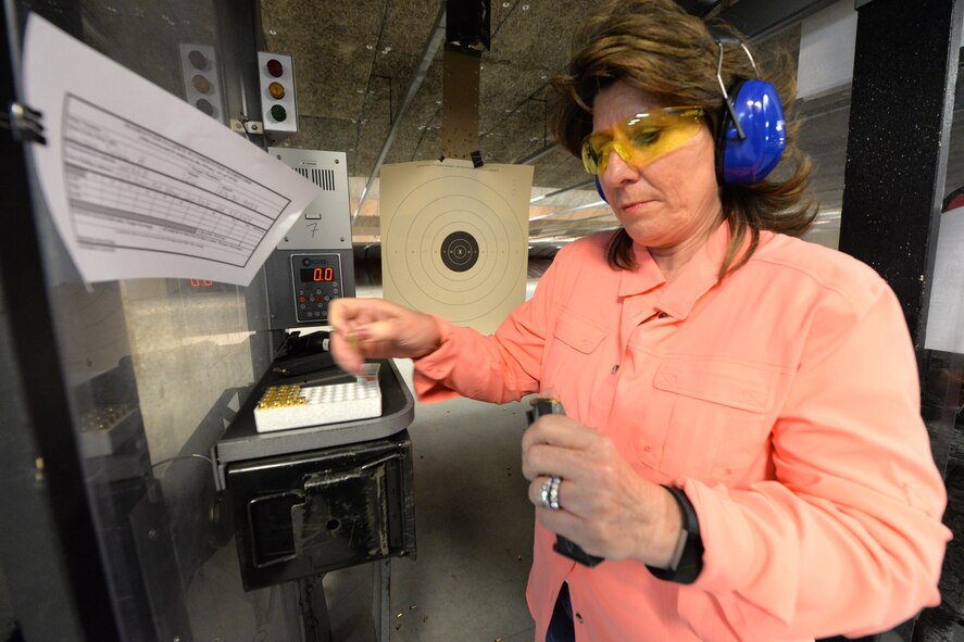 Tammy Davison, HQ Air Force Materiel Command human resource senior leader manager, loads her M-9 9mm pistol 20-round clip prior to shooting in the Excellence in Competition marksmanship contest at the 88th Security Forces Squadron gun range April 5, 2017. The April 3-13 EIC event conducted Air Force-wide was open to all active duty, Guard, Reserve, retiree and civil service employees. (U.S. Air Force photo/Al Bright)