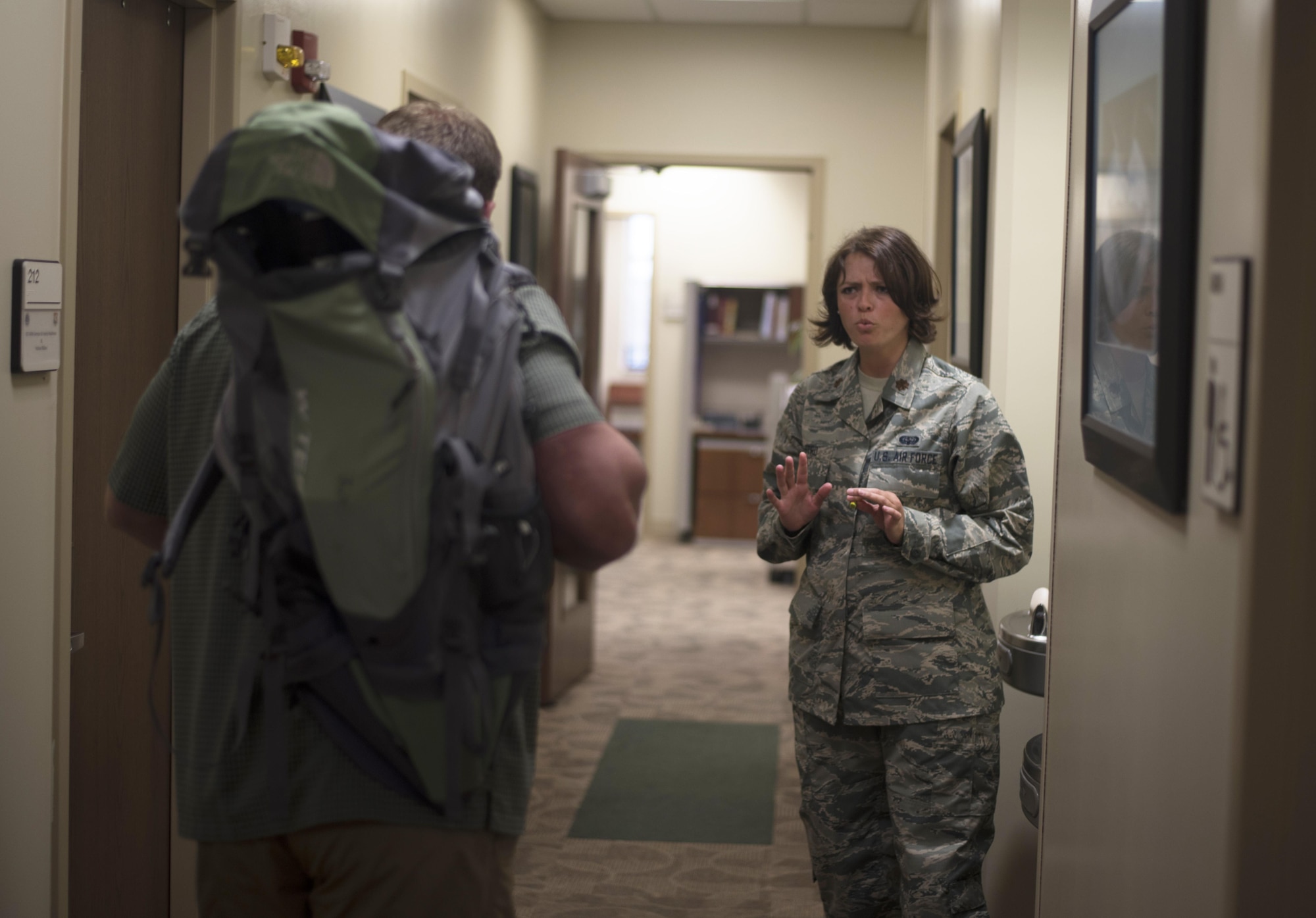 U.S. Air Force Maj. Taya Castro, an executive officer assigned to the 927th Air Refueling Wing, attempts to reconcile with an armed gunman during an active shooter exercise at MacDill Air Force Base, Fla., April 17, 2017. The exercise was created to test the speed of emergency response teams on MacDill. (U.S. Air Force photo by Airman 1st Class Adam R. Shanks)