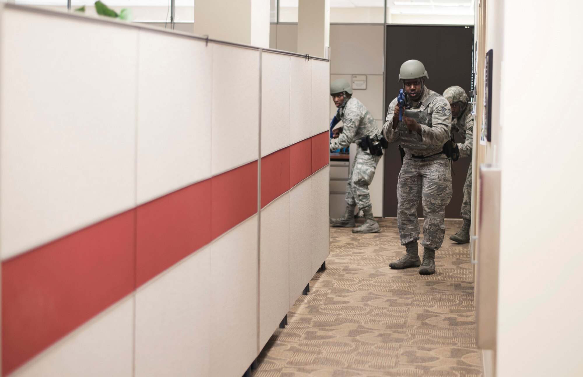 Airmen assigned to the 6th Security Forces Squadron conduct a sweep at the 927th Air Refueling Wing headquarters during an active shooter exercise at MacDill Air Force Base, Fla., April 17, 2017. During the sweep, the defenders searched for any other threats in the building (U.S. Air Force photo by Airman 1st Class Adam R. Shanks)