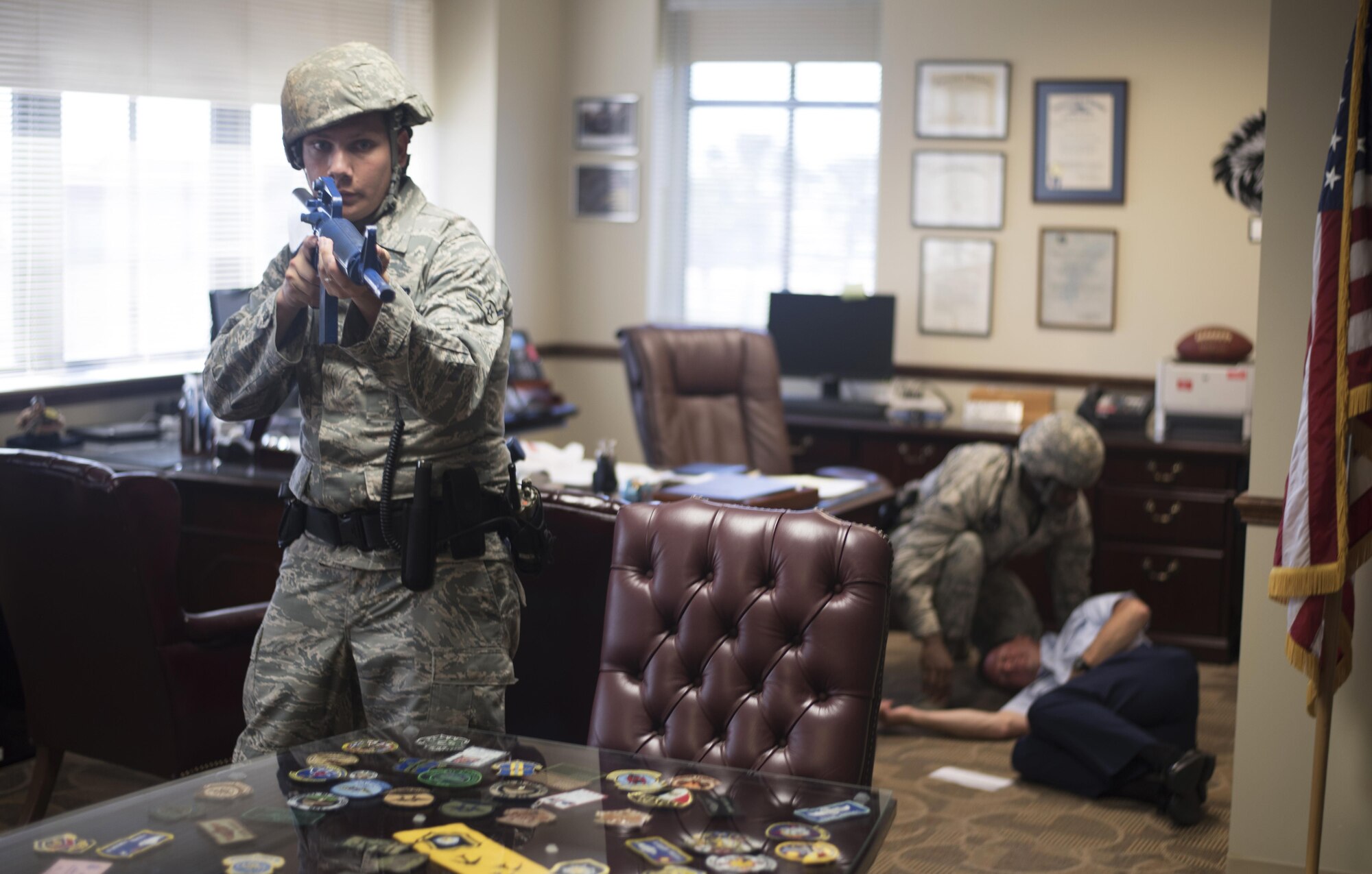 U.S. Air Force Airman Aaron Vieira, an entry controller assigned to the 6th Security Forces Squadron, provides protection over U.S. Air Force Col. Frank Amodeo, the commander of the 927th Air Refueling Wing during an active shooter exercise, April 17, 2017 at MacDill Air Force Base, Fla. Amodeo received a simulated gunshot wound to the abdomen after notifying emergency services. (U.S. Air Force photo by Airman 1st Class Adam R. Shanks)