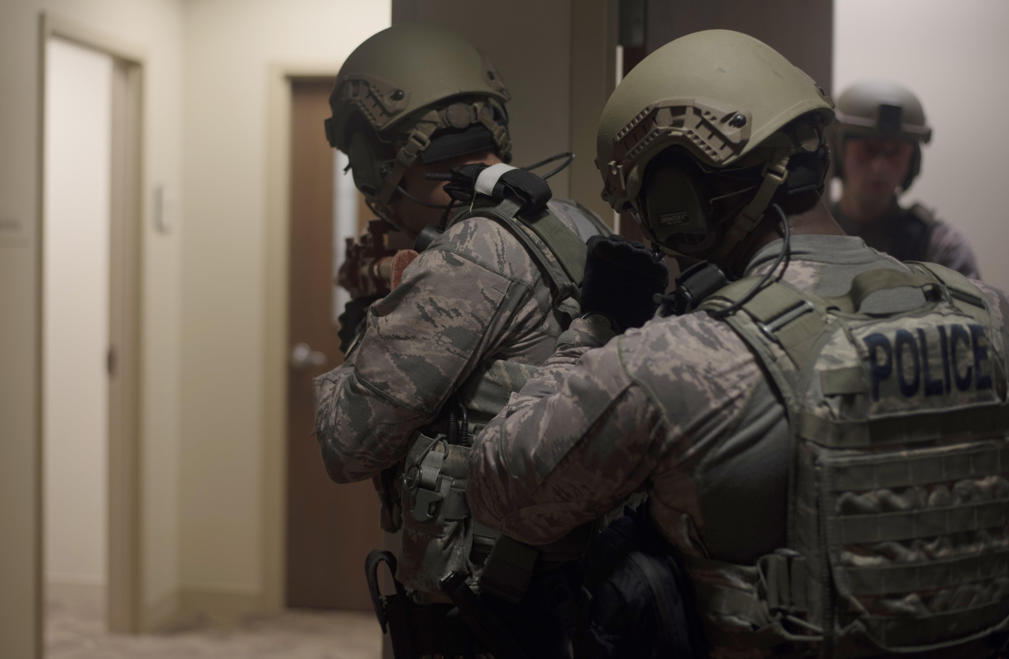 Members of the emergency services team assigned to the 6th Security Forces Squadron, group together to begin searching for casualties during an active shooter exercise at MacDill Air Force Base, Fla., April 17, 2017. With multiple teams searching different areas of the building, communication was important in order to quickly search the entire building. (U.S. Air Force photo by Airman 1st Class Adam R. Shanks)