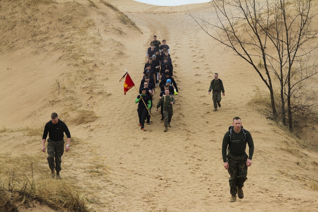 Future Marines hike with U.S. Marine Corps Maj. Christopher Hart, right, and Marine Corps recruiters from Recruiting Sub-Station Cadillac at the Sleeping Bear Dunes National Lakeshore, Empire, Michigan, April 15, 2017. During the five-mile hike, the team rehearsed Marine Corps terminology as well as prepared for the physical demands of Marine Corps Recruit Depot, Parris Island, South Carolina. (U.S. Marine Corps photo by Sgt. Immanuel M. Johnson/Released)