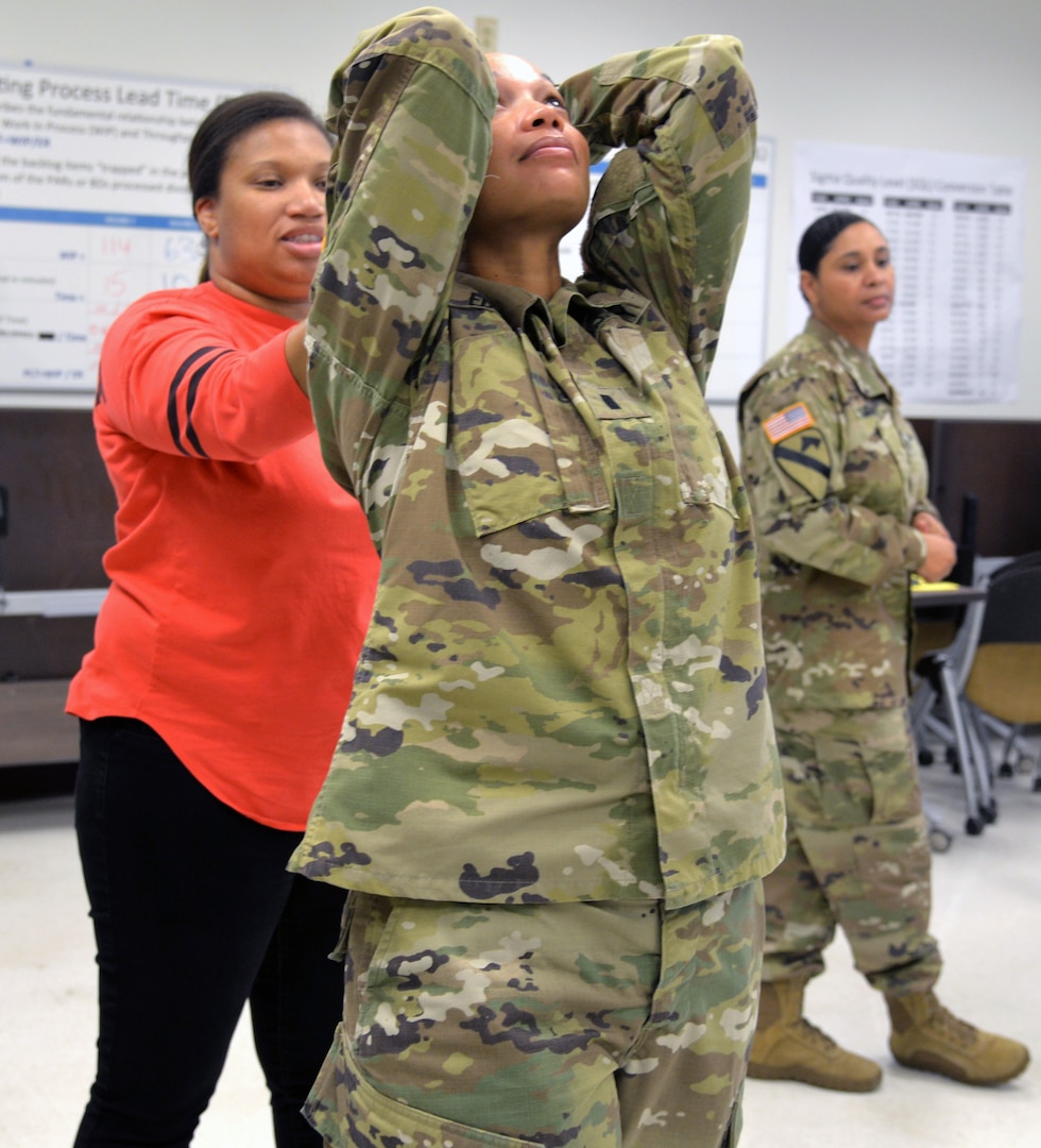 Military medical professionals practice de-escalation and therapeutic containment techniques, known as Prevention and Management of Disrupted Behavior-Military, during a training session April 13 at the U.S. Army Medical Department Center and School. The session was part of a week-long training program for military medical professionals, who learned skills that will help them calm and settle down patients in crisis at military treatment facilities.