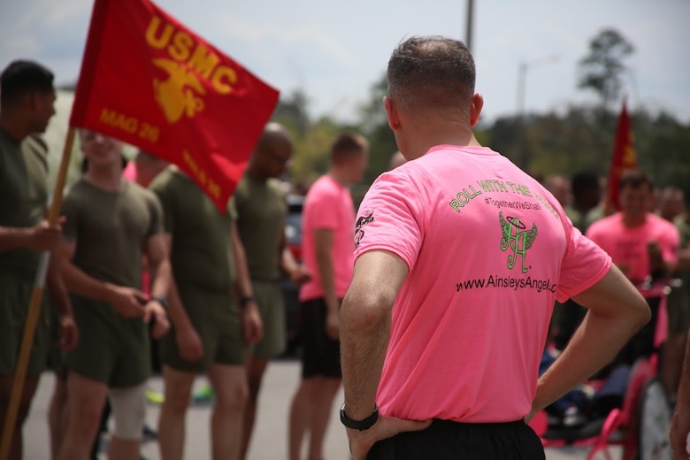 Lt. Col. Edward H. Carpenter looks over at a crowd of Marines during a unit volunteer event at Marine Corps Air Station New River, N.C., April 13, 2017. More than 220 Marines assigned to Marine Aviation Logistics Squadron 26, Marine Aircraft Group 26, 2nd Marine Aircraft Wing,  gathered to run with disabled children as part of an Ainsley’s Angels East Carolina chapter event at the air station. ( U.S. Marine Corps photo by Sgt. N.W. Huertas/ Released)