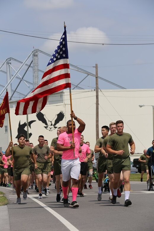 Marines call cadences during a formation run at Marine Corps Air Station New River, N.C., April 13, 2017. More than 220 Marines assigned to Marine Aviation Logistics Squadron 26, Marine Aircraft Group 26, 2nd Marine Aircraft Wing  gathered to run with disabled children as part of an Ainsley’s Angels East Carolina chapter event at the air station. The unit participated in the event to show their support for the local community and share their Espirit De Corps. ( U.S. Marine Corps photo by Sgt. N.W. Huertas/ Released)