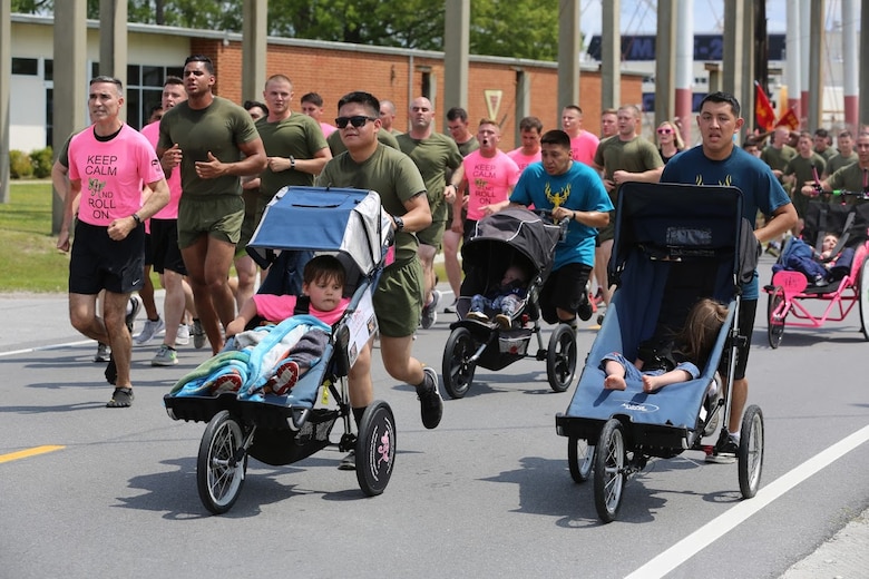 Marines push athlete riders along side other Marines during a formation run at Marine Corps Air Station New River, N.C., April 13, 2017. More than 220 Marines assigned to Marine Aviation Logistics Squadron 26, Marine Aircraft Group 26, 2nd Marine Aircraft Wing  came together to run with disabled children for an Ainsley’s Angels East Carolina chapter event. The unit participated in the event to show their support for the local community and share their Espirit De Corps. ( U.S. Marine Corps photo by Sgt. N.W. Huertas/ Released)