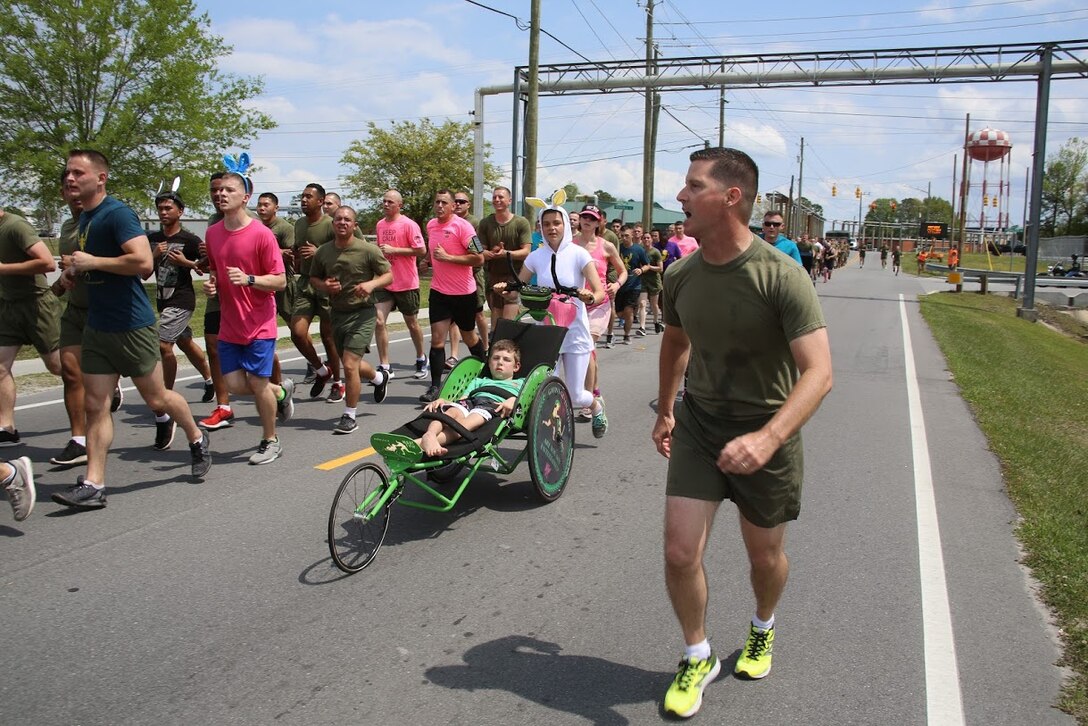 Marines call cadences during a formation run at Marine Corps Air Station New River, N.C., April 13, 2017. More than 220 Marines assigned to Marine Aviation Logistics Squadron 26, Marine Aircraft Group 26, 2nd Marine Aircraft Wing  gathered to run with disabled children as part of an Ainsley’s Angels East Carolina chapter event at the air station. Many Marines dressed in easter themed costumes as a way to celebrate the season and show their support to the organization. ( U.S. Marine Corps photo by Sgt. N.W. Huertas/ Released)