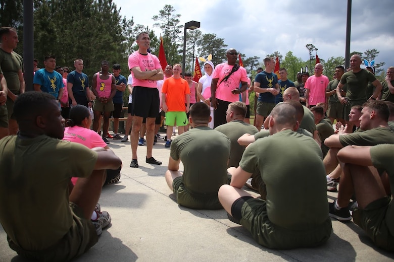 Lt. Col. Edward H. Carpenter and senior leaders adress a crowd of Marines during a unit volunteer event at Marine Corps Air Station New River, N.C., April 13, 2017. More than 220 Marines assigned to Marine Aviation Logistics Squadron 26, Marine Aircraft Group 26, 2nd Marine Aircraft Wing  gathered to run with disabled children as part of an Ainsley’s Angels East Carolina chapter event at the air station. Carpenter is the commanding officer of MALS-26. ( U.S. Marine Corps photo by Sgt. N.W. Huertas/ Released)