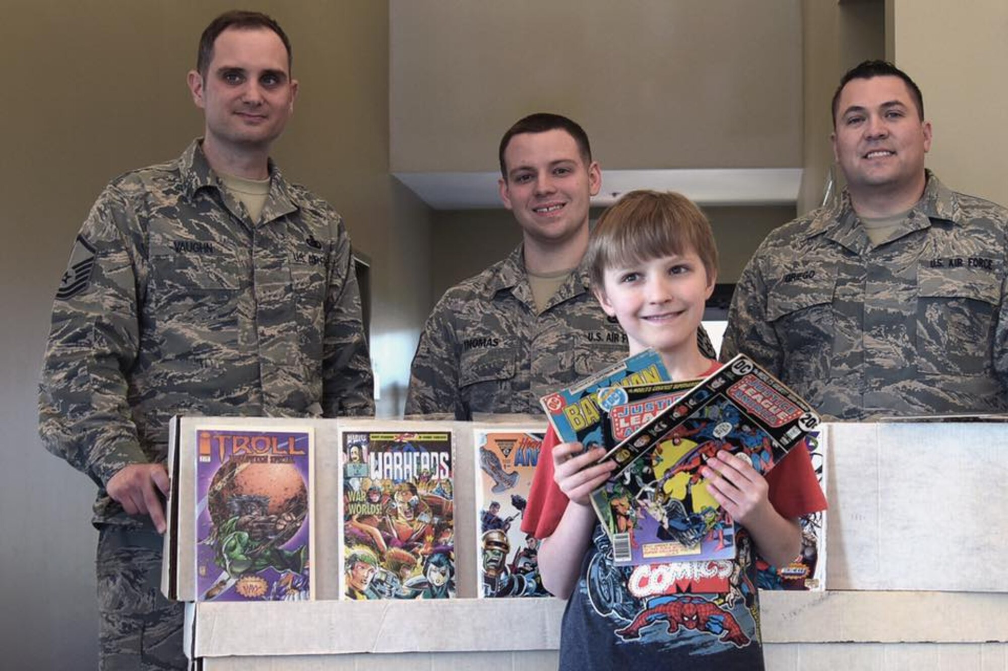 Carl Scheckel shows off a few of the 3,000 comic books donated to service members at the Military and Family Service Center on Joint Base McGuire-Dix-Lakehurst, New Jersey, April, 2017. The donated comic books are being sent to deployed servicemembers around the globe.