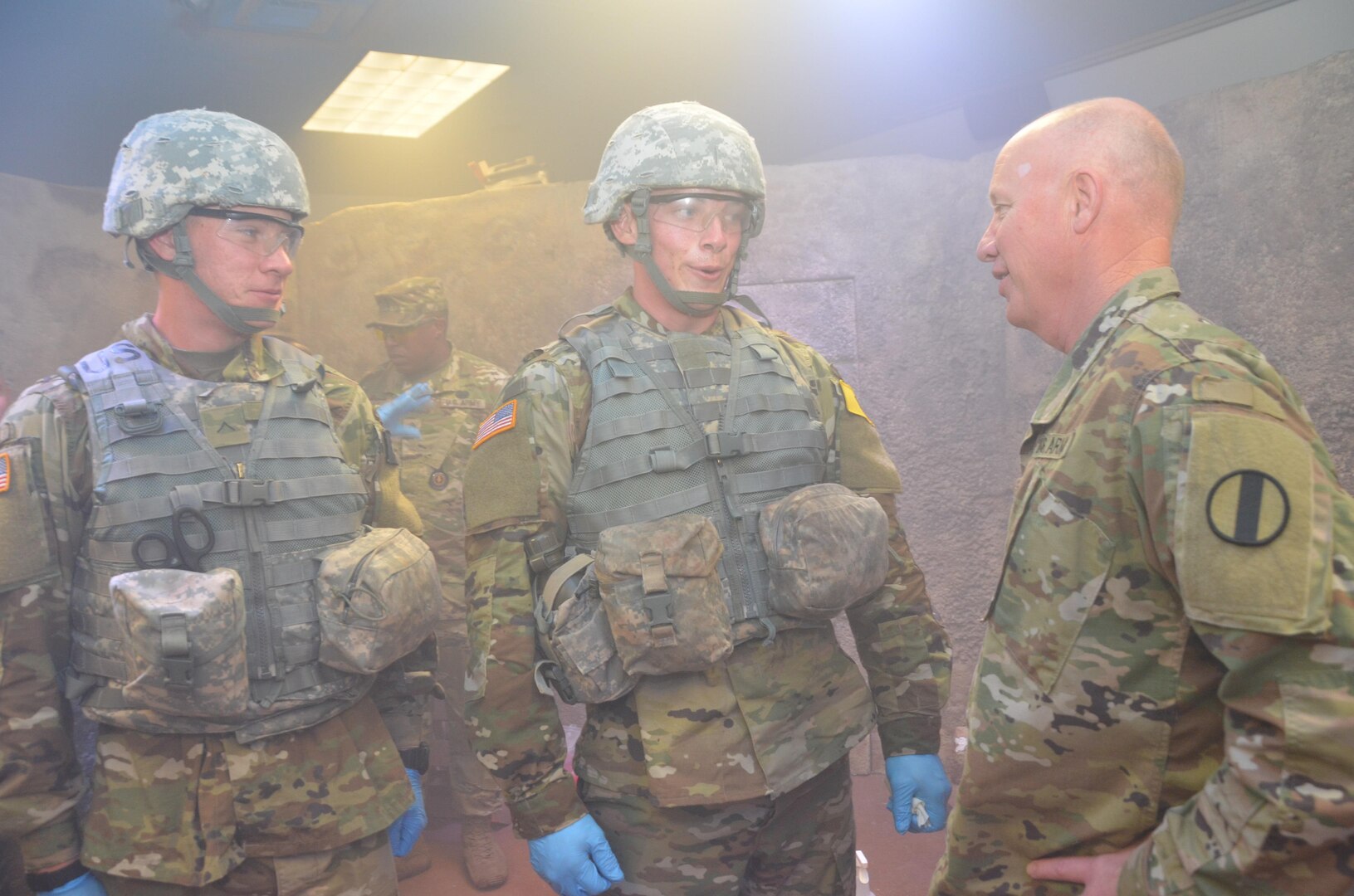 Maj. Gen. Glen Moore (right), deputy commanding general, Army National Guard, U.S. Army Training and Doctrine Command, speaks with Army students in the combat medic training program at the Medical Education and Training Campus at Joint Base San Antonio-Fort Sam Houston April 14. Moore observed the students as they trained in the Combat Trauma Patient Simulator, a simulation lab that provides a realistic type of training experience for students learning how to treat trauma wounds on casualties in a combat environment. About half of the students in the combat medic training program are in the National Guard or Army Reserve.