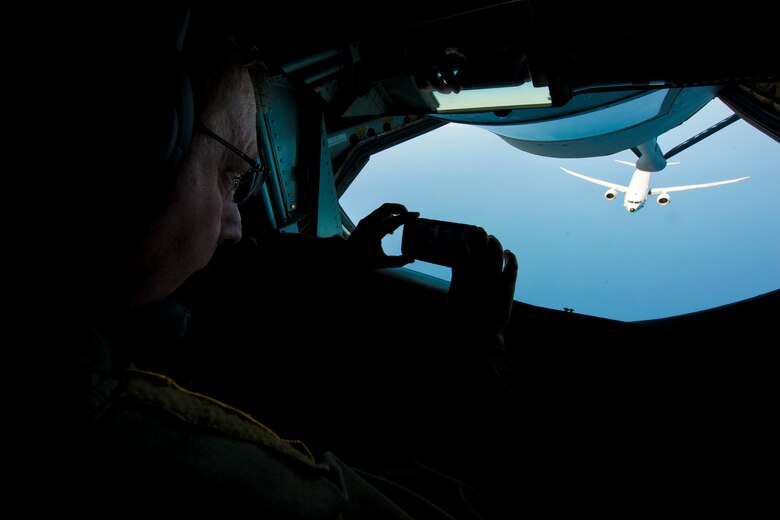 Chief Master Sgt. Frankie Rollins, 756th Refueling Squadron superintendent and boom operator, takes a picture of an incoming Naval Air Systems Command P-8A Poseidon over the Atlantic Ocean April 13, 2017. This was the first successful inflight refueling of the P-8A after a year of planning and coordination with NAVAIR. (U.S. Air Force photo/Tech. Sgt. Kat Justen)