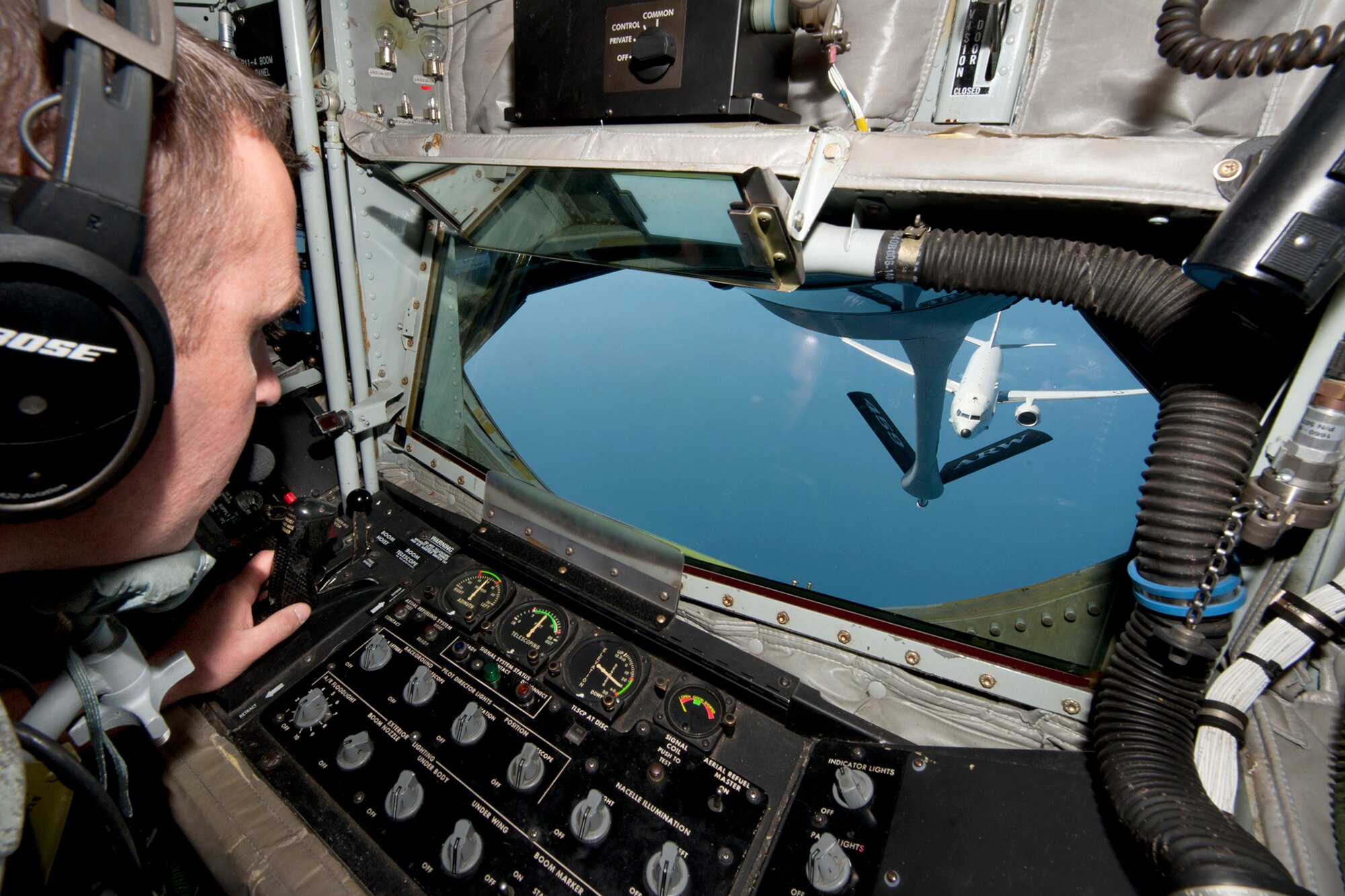Tech. Sgt. Steve Hood, 756th Air Refueling Squadron boom operator, watches as a Naval Air Systems Command P-8A Poseidon comes in on approach for an inflight refueling over the Atlantic Ocean April 13, 2017. This was the first inflight refueling of the P-8A after a year of planning with NAVAIR. The P-8A is only the second-ever Navy aircraft to be fitted with a receiver for aerial refueling; the first being the E-6B Mercury nearly 30 years ago. (U.S. Air Force photo/Tech. Sgt. Kat Justen)