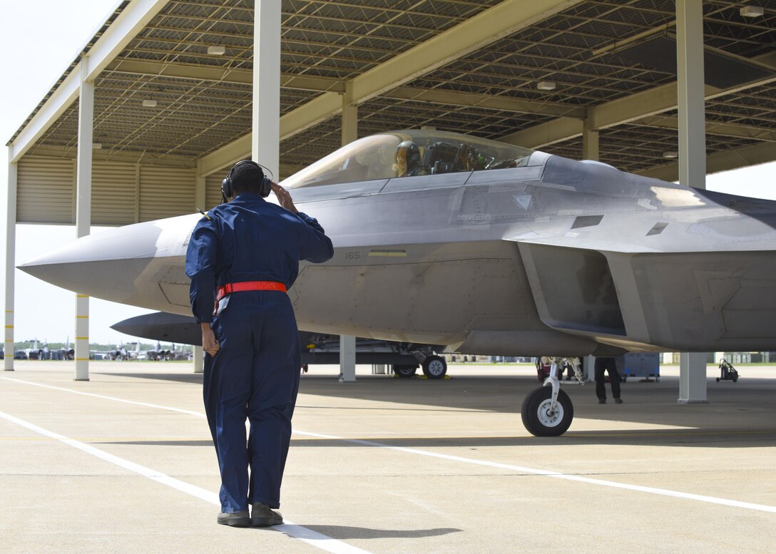 U.S. Air Force Airman 1st Class Devonte Prescott, 1st Maintenance Squadron, 27th Aircraft Maintenance Unit crew chief, salutes an F-22 Raptor pilot during ATLANTIC TRIDENT 17 at Joint Base Langley-Eustis, Va., April 18, 2017. The F-22, a critical component of the Global Strike Task Force, is designed to project air dominance, rapidly and at great distances, to defeat threats. (U.S. Air Force photo/Airman 1st Class Anthony Nin Leclerec)