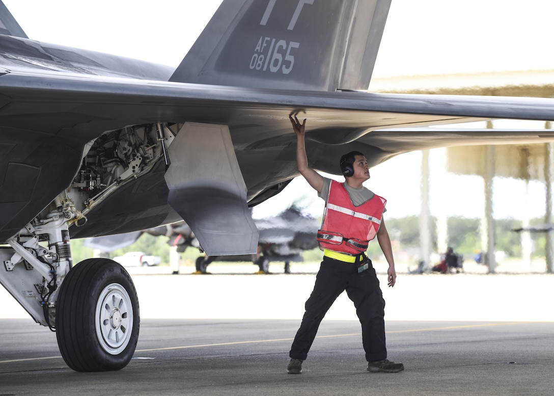 A U.S. Air Force crew chief from the 1st Maintenance Squadron, 27th Aircraft Maintenance Unit, inspects an F-22 Raptor during ATLANTIC TRIDENT 17 at Joint Base Langley-Eustis, Va., April 18, 2017. Its combination of stealth, supercruise, maneuverability and integrated avionics, coupled with improved supportability, represents a leap in warfighting capabilities. (U.S. Air Force photo/Airman 1st Class Anthony Nin Leclerec)