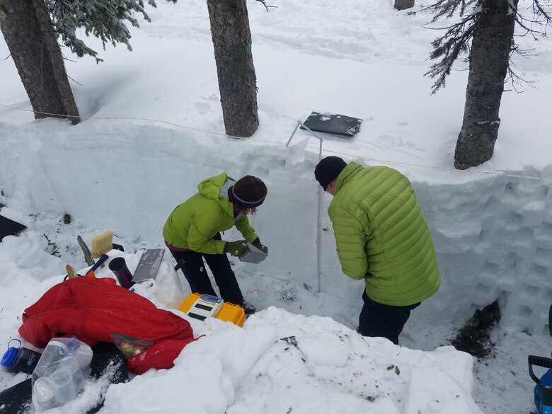 CRREL’s Drs. Anna Wagner (left) and Andrew Klein, Texas A&M University, collect snow density samples from a snow pit.