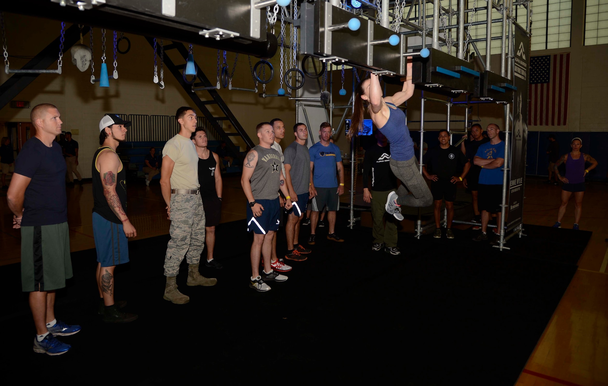 Barclay Stockett, center right, an Alpha Warrior pro, demonstrates a station of a Battle Rig obstacle course as members of Team MacDill observe at MacDill Air Force Base, Fla., April 19, 2017. The Alpha Warrior team demonstrated each station before releasing participants to try each station for themselves. (U.S. Air Force photo by Staff Sgt. Vernon L. Fowler Jr.)