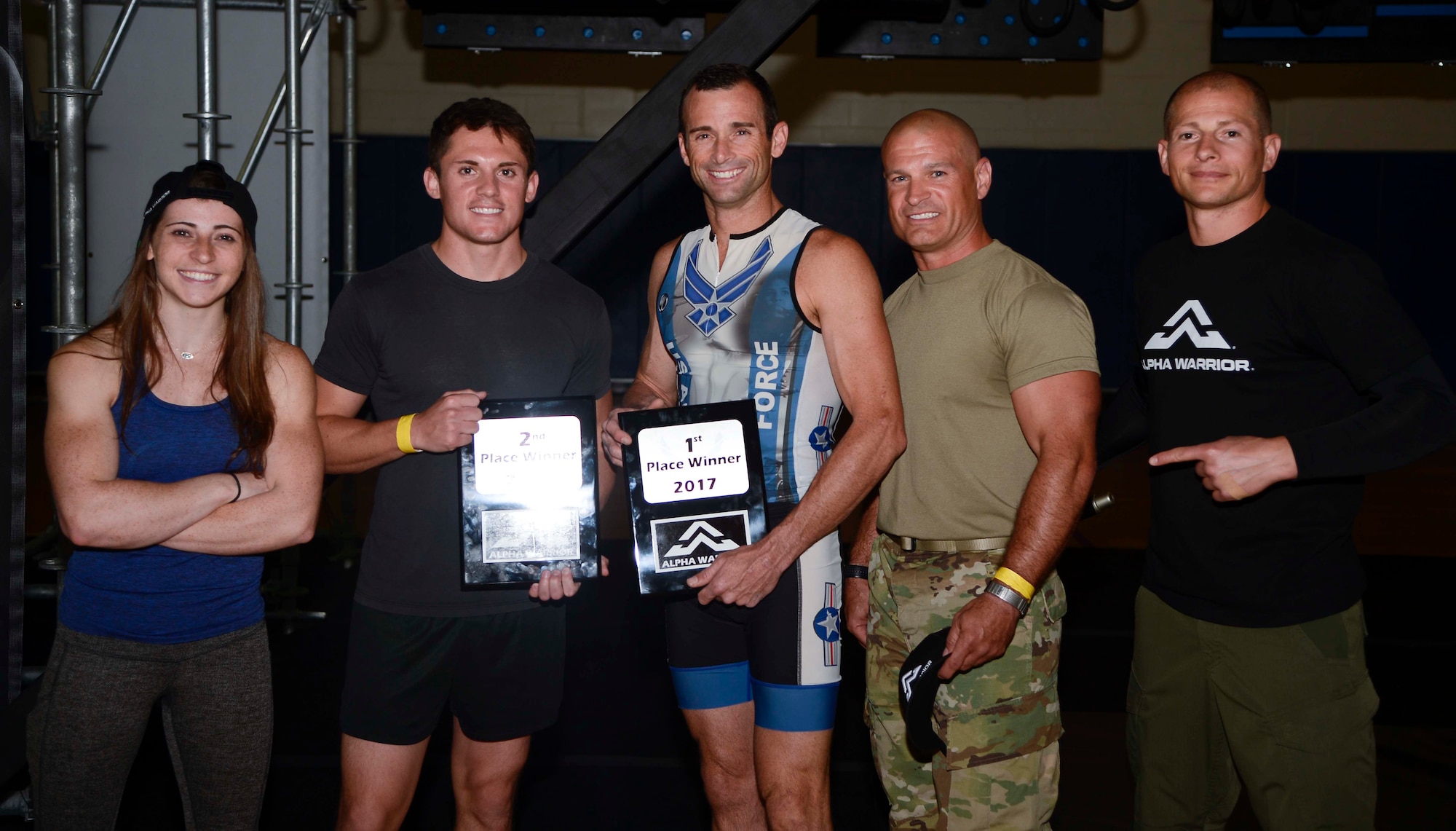 Barclay Stockett, far left, and Brent Steffensen, far right, both Alpha Warrior pros, pause for a photo with the top three winners of the Alpha Warrior Battle Rig competition at MacDill Air Force Base, Fla., April 19, 2017. Participants each received five minutes to successfully complete the obstacle course, and the top three fastest times were selected as winners. (U.S. Air Force photo by Staff Sgt. Vernon L. Fowler Jr.)