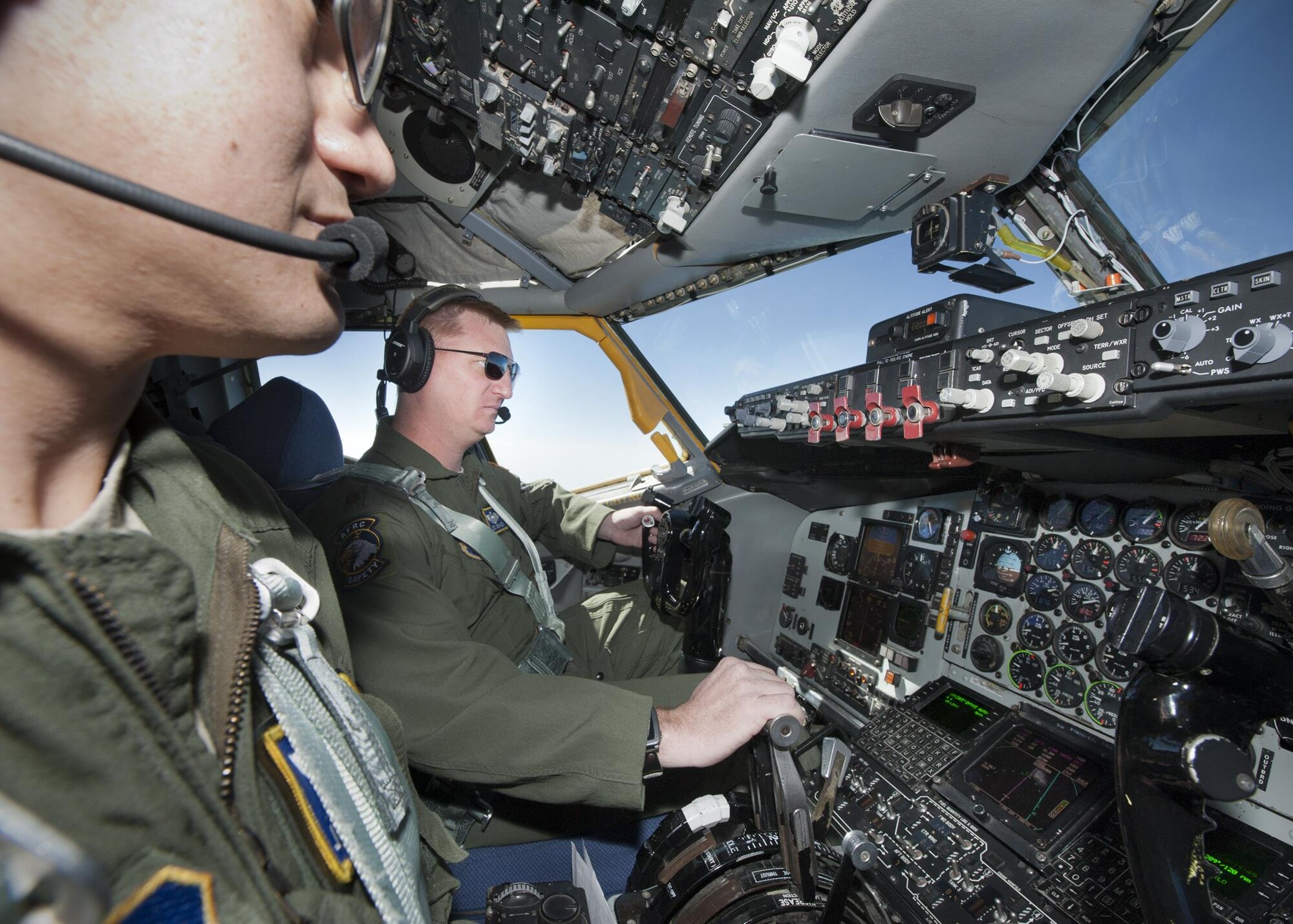 Major Eric Graves, 756th Air Refueling Wing pilot, checks his gauges during a flight over the Atlantic Ocean April 13, 2017. During the flight the 756 ARW conducted the first-ever refueling mission with a Naval Air Systems Command P-8A Poseidon after a year of planning with NAVAIR. (U.S. Air Force photo/Tech. Sgt. Kat Justen)
