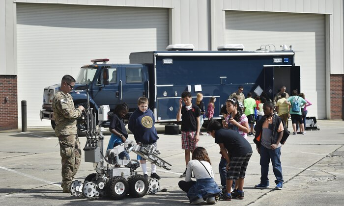 Staff Sgt. Joshua Rickert, 628th Civil Engineer Squadron explosive ordinance, disposal, shows 5th-grade students from Sedgefield Intermediate School basic functions of an F6A robot as part of a career day event at Joint Base Charleston, S.C., April 20, 2017. The students talked to Airmen and participated in various career field specific demonstrations alongside subject matter experts from various units on the installation. Junior Reserve Officer Training Corps members from Fort Dorchester High School, Orangeburg Wilkinson High School, Summerville High School and Military Magnet Academy were also attended the event.