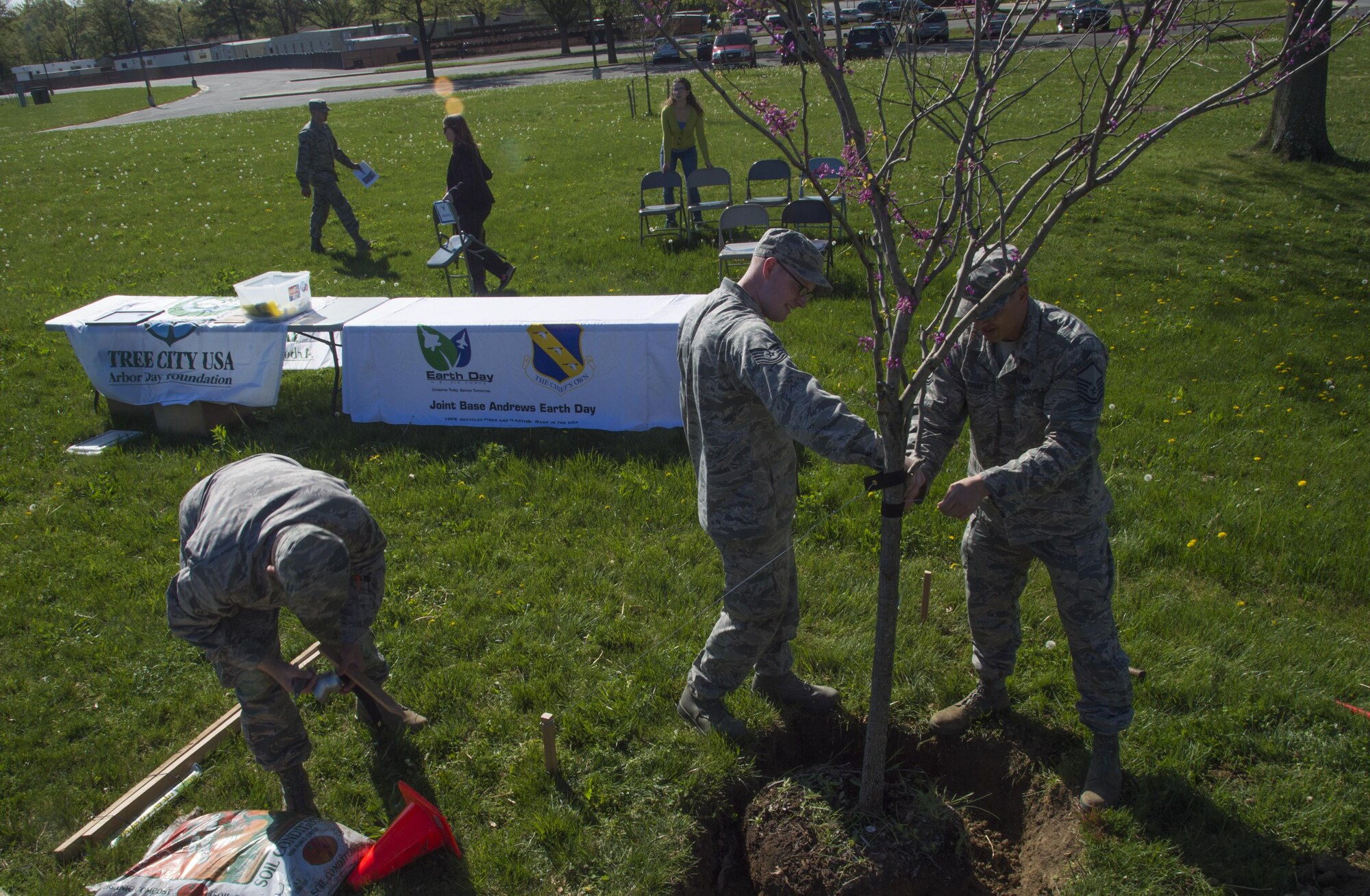 Airmen volunteer at a tree-planting ceremony in celebration of Earth Week and Arbor Day at Joint Base Andrews, Md., April 18, 2017. During the ceremony, Col. E. John Teichert, 11th Wing and JBA commander, received awards from the Maryland Department of Natural Resources for the base’s continuing contributions to environmental services. (U.S. Air Force photo by Senior Airman Mariah Haddenham)