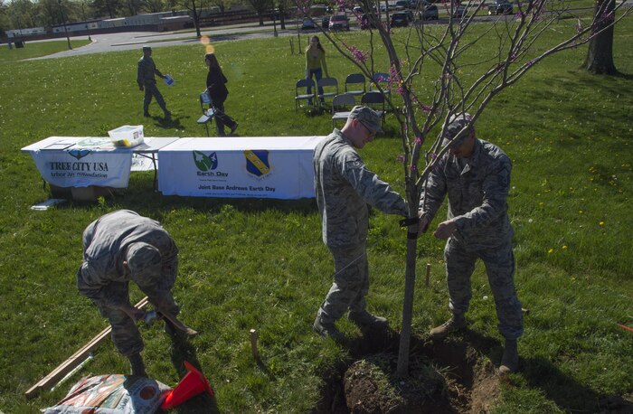 Airmen volunteer at a tree-planting ceremony in celebration of Earth Week and Arbor Day at Joint Base Andrews, Md., April 18, 2017. During the ceremony, Col. E. John Teichert, 11th Wing and JBA commander, received awards from the Maryland Department of Natural Resources for the base’s continuing contributions to environmental services. (U.S. Air Force photo by Senior Airman Mariah Haddenham)