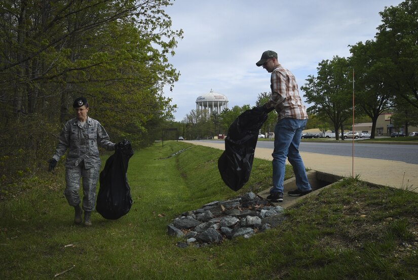 Lt. Col. Sarah Isbill, 811th Security Forces Squadron commander, volunteers to pick up trash during Earth Week on Joint Base Andrews, Md., April 19, 2017. The week also included a tree planting ceremony, seed planting, and a youth art display. (U.S. Air Force photo by Senior Airman Mariah Haddenham)
