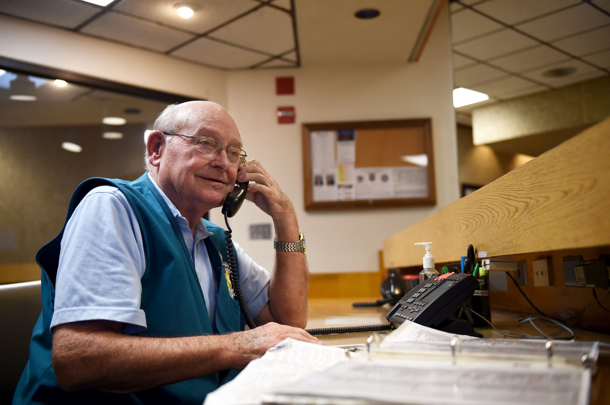 Wilford Hall volunteer Jack Kuttner answers the phone while manning the information desk at the Wilford Hall Ambulatory Surgical Center, Joint Base San Antonio-Lackland, Texas, April 12, 2017. Volunteers can be spotted throughout Wilford Hall assisting patients and staff members. (U.S. Air Force photo/Staff Sgt. Jerilyn Quintanilla)