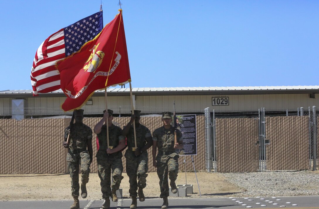 The Combat Center Color Guard prepares to present the National and Marine Corps colors during the renaming ceremony of Calcite Road to Diaz Road, April 14, 2017, aboard the Marine Corps Air Ground Combat Center, Twentynine Palms, Calif. The road was renamed in honor of Staff Sgt. Christopher Diaz who made the ultimate sacrifice to help a brother in arms while conducting combat operations in Helmand Province, Afghanistan in support of Operation Enduring Freedom. (U.S. Marine Corps photo by Cpl. Medina Ayala-Lo)