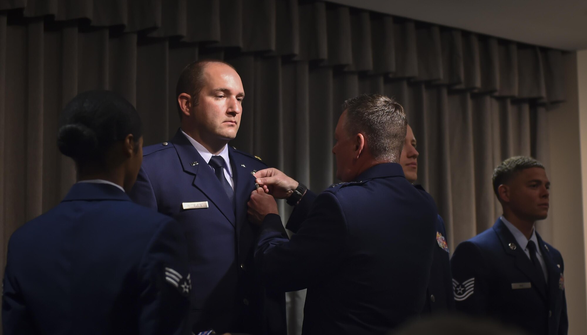 Maj. Ryan Mittelstet is presented the Distinguished Flying Cross by Lt. Gen. Brad Webb, commander of Air Force Special Operations Command, during a ceremony at Hurlburt Field, Fla., April 21, 2017. The DFC is a medal awarded to any officer or enlisted member of the U.S. armed forces, who distinguishes himself or herself in combat in support of operations by heroism or extraordinary achievement while participating in an aerial flight. (U.S. Air Force photo by Airman 1st Class Joseph Pick)