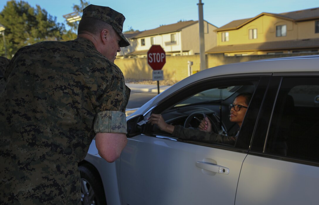 Maj. Gen. Mark Wise, commanding general of 3rd Marine Aircraft Wing, welcomed service members and civilian employees to work at the North Gate on Marine Corps Air Station Miramar, Calif., April 21.Wise, along with Col. Jason Woodworth, commanding general of MCAS Miramar, Sgt. Maj. James Porterfield, sergeant major of 3rd MAW, and Sgt. Maj. Michael Walton, sergeant major of MCAS Miramar, welcomed everyone traveling through the gate to raise awareness of Sexual Assault and Prevention month. “It is the responsibility of every member of the command to prevent and report incidents of sexual assault,” said Woodworth. “Treat each other as you want to be treated and remember to do the right thing the first time, every time.” (Marine Corps photo by Sgt. Kimberlyn Adams/Released)
