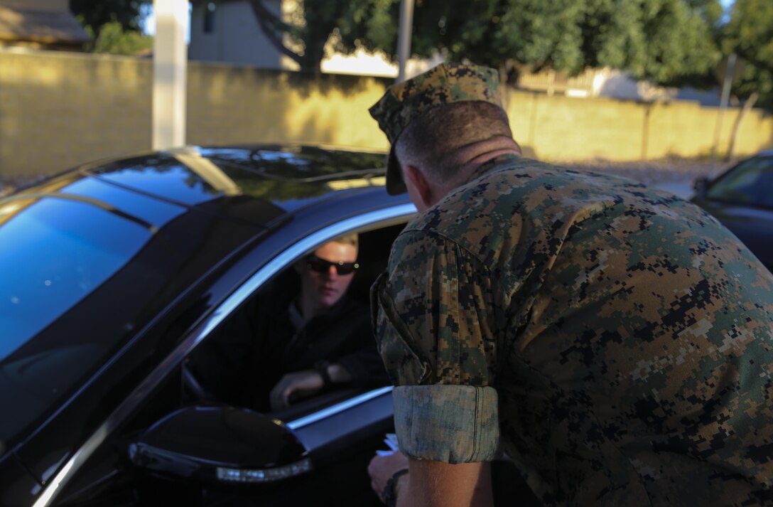 Col. Jason Woodworth, commanding officer of Marine Corps Air Station Miramar, Calif., welcomes a Marine to work at the North Gate on MCAS Miramar, April 21. Woodworth, along with Maj. Gen. Mark Wise, commanding general of 3rd Marine Aircraft Wing, Sgt. Maj. James Porterfield, sergeant major of 3rd MAW, and Sgt. Maj. Michael Walton, sergeant major of MCAS Miramar, welcomed service members and civilian employees traveling through the gate to raise awareness of Sexual Assault and Prevention month. “It is the responsibility of every member of the command to prevent and report incidents of sexual assault,” said Woodworth. “Treat each other as you want to be treated and remember to do the right thing the first time, every time.” (Marine Corps photo by Sgt. Kimberlyn Adams/Released)