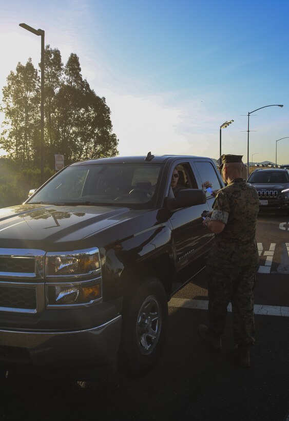 Sgt. Maj. Michael Walton, sergeant major of Marine Corps Air Station Miramar, Calif., welcomes a Marine to work at the East Gate on MCAS Miramar, April 21. Walton, along with Maj. Gen. Mark Wise, commanding general of 3rd Marine Aircraft Wing, Col. Jason Woodworth, commanding officer of MCAS Miramar and Sgt. Maj. James Porterfield, sergeant major of 3rd MAW, welcomed service members and civilian employees traveling through the gate to raise awareness of Sexual Assault and Prevention month. “It is the responsibility of every member of the command to prevent and report incidents of sexual assault,” said Woodworth. “Treat each other as you want to be treated and remember to do the right thing the first time, every time.” (Marine Corps photo by Sgt. Kimberlyn Adams/Released)