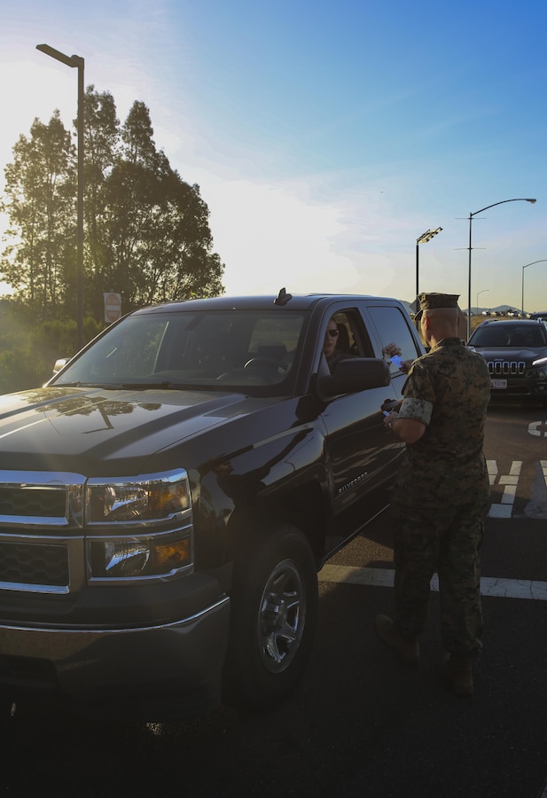 Sgt. Maj. Michael Walton, sergeant major of Marine Corps Air Station Miramar, Calif., welcomes a Marine to work at the East Gate on MCAS Miramar, April 21. Walton, along with Maj. Gen. Mark Wise, commanding general of 3rd Marine Aircraft Wing, Col. Jason Woodworth, commanding officer of MCAS Miramar and Sgt. Maj. James Porterfield, sergeant major of 3rd MAW, welcomed service members and civilian employees traveling through the gate to raise awareness of Sexual Assault and Prevention month. “It is the responsibility of every member of the command to prevent and report incidents of sexual assault,” said Woodworth. “Treat each other as you want to be treated and remember to do the right thing the first time, every time.” (Marine Corps photo by Sgt. Kimberlyn Adams/Released)