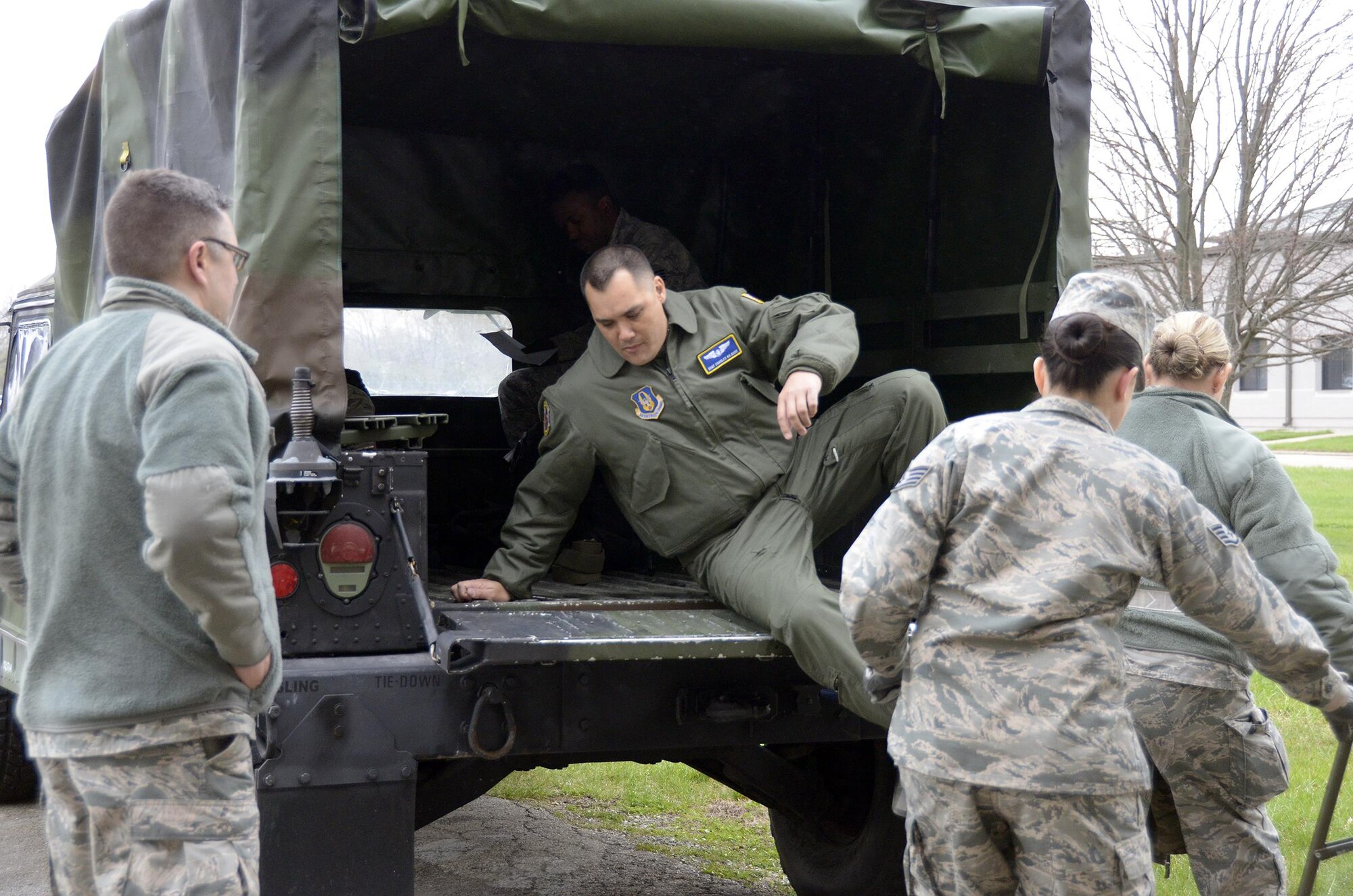 Staff Sgt. Charles Kilgore, a medical technician from the 445th Aeromedical Evacuation Squadron, climbs into the back of a vehicle in preparation for transport to the flightline during a home station exercise on April 1, 2017. Kilgore portrayed the role of a patient during the exercise. (U.S. Air Force photo/Staff Sgt. Joel McCullough)