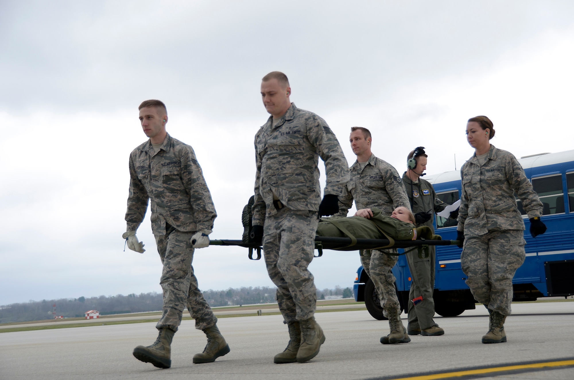 445th Aeromedical Staging Squadron Airmen perform a four-person litter carry on the flightline April 1, 2017. The Airmen carried a “patient” from a bus to a 445th Airlift Wing C-17 Globemaster III as part of a home station exercise alongside Airmen from the 445th Aeromedical Evacuation Squadron. (U.S. Air Force photo/Staff Sgt. Joel McCullough)