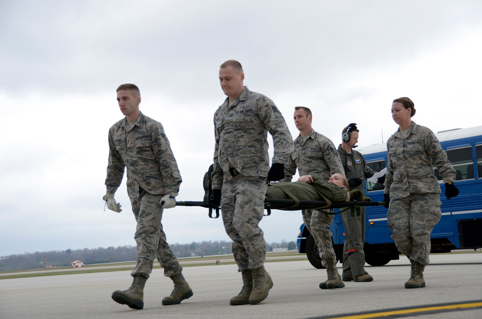 445th Aeromedical Staging Squadron Airmen perform a four-person litter carry on the flightline April 1, 2017. The Airmen carried a “patient” from a bus to a 445th Airlift Wing C-17 Globemaster III as part of a home station exercise alongside Airmen from the 445th Aeromedical Evacuation Squadron. (U.S. Air Force photo/Staff Sgt. Joel McCullough)