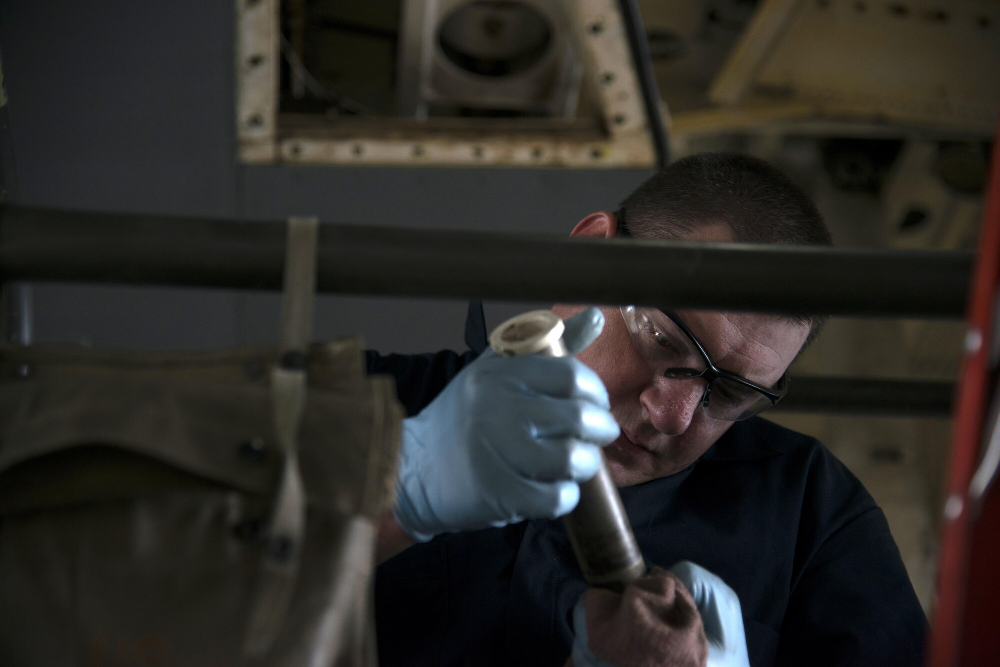 U.S. Air Force Tech. Sgt. Patrick Register, an aerospace repair technician assigned to the 6th Maintenance Squadron, prepares a tube of grease prior to use on a KC-135 Stratotanker aircraft, April 10, 2017, at MacDill Air Force Base Fla. Register was part of a team tasked to inspect an aircraft after a hard landing was reported. (U.S. Air Force photo by Airman 1st Class Rito Smith) 