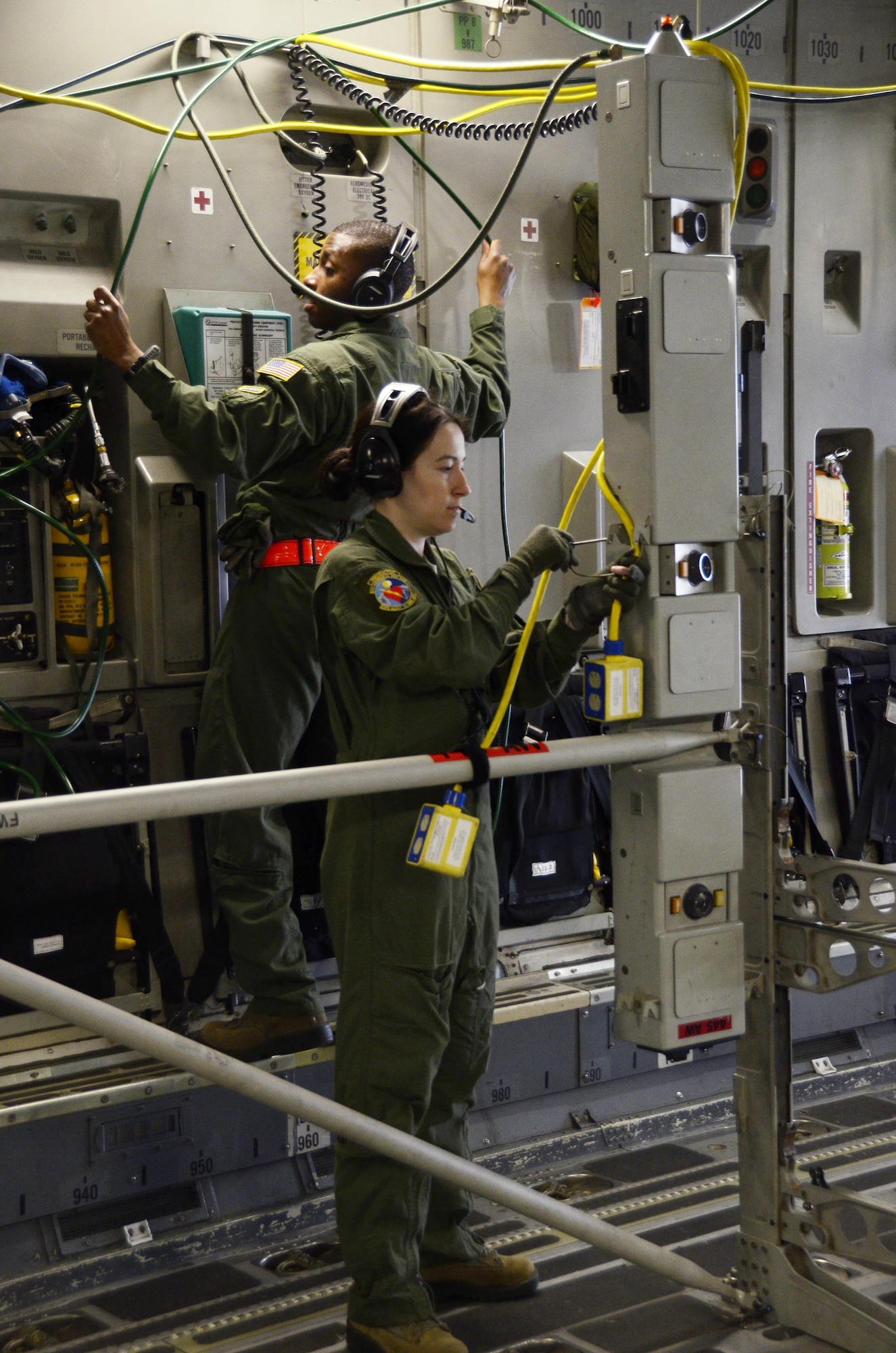 Master Sgt. Erika Algeo and Senior Airman Lawrence Mark, both medical technicians with the 445th Aeromedical Evacuation Squadron, set up a litter stanchion on a 445th Airlift Wing C-17 Globemaster III, April 1, 2017. The two participated in a home station exercise that included not only 445th AES Airmen but Airmen from the 445th Aeromedical Staging Squadron. (U.S. Air Force photo/Staff Sgt. Joel McCullough)